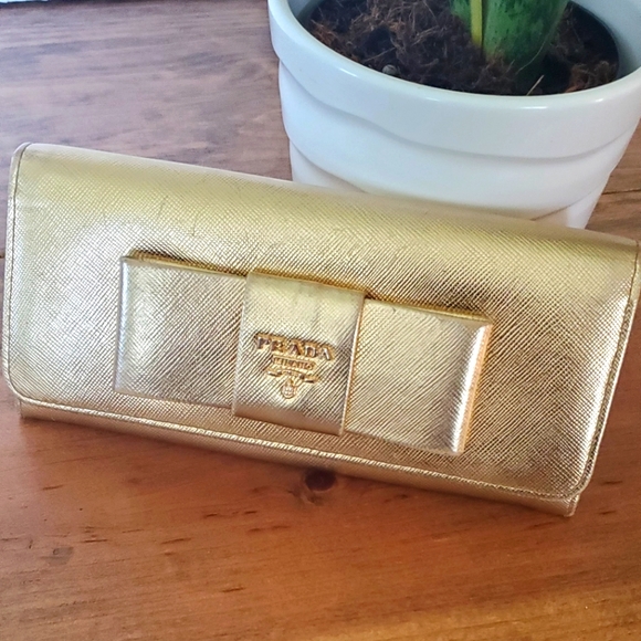 Prada Handbags - Authentic PRADA saffiano bow gold flap wallet